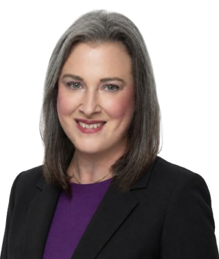 Head-and-shoulders portrait of a smiling woman with gray hair, wearing a black blazer and purple top.